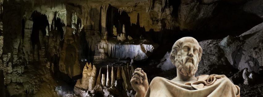 Interior of a cave with human shadow throughout. A bust of Plato is in front