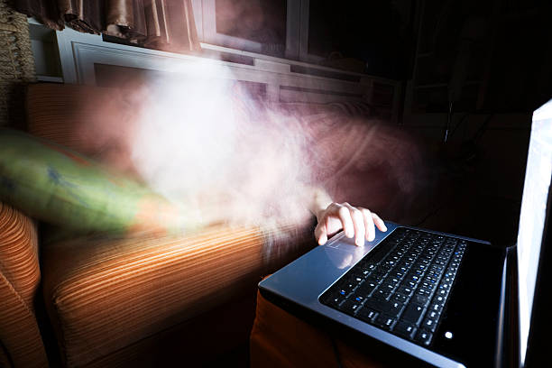 An ethreal mist reaches out from a sofa to touch a laptop