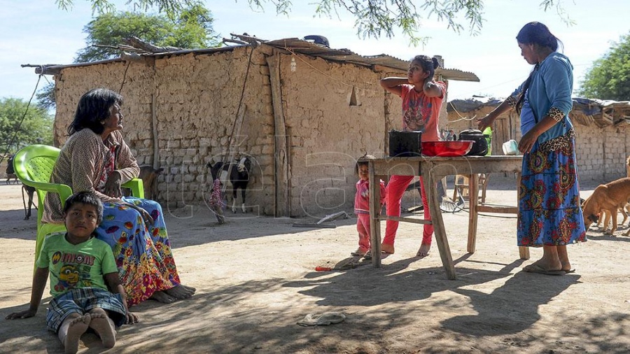 A sunny village with native people sitting in the shade