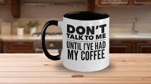 A coffee mug reading Don't talk to me until I've had my coffee sits on a wooden kitchen counter