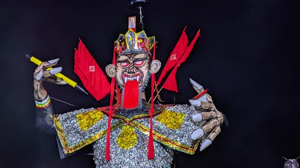 A large statue of an Asian God with its tongue sticking out