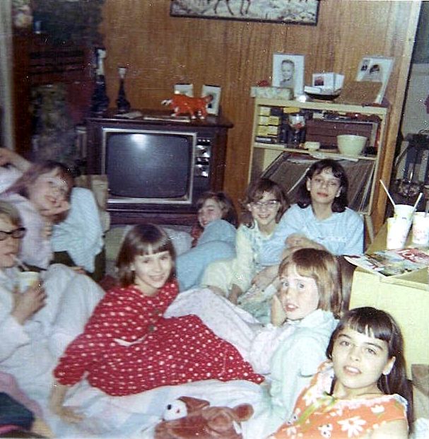 A group of girls pose in a living room during a slumber party