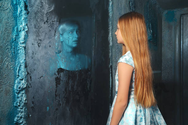 A young girl looks in the mirror to see a scary face looking back at her