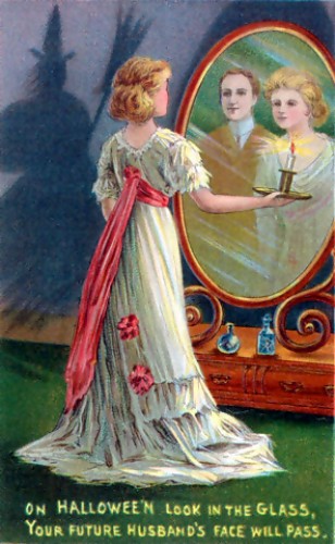 A phto depicting a young woman looking in the mirror by candlelight and seeing her beloved while a shadow of a witch is seen on the wall