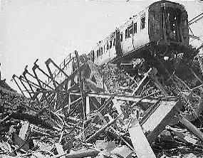 WWII photo depicting the ruin of a train track and train car